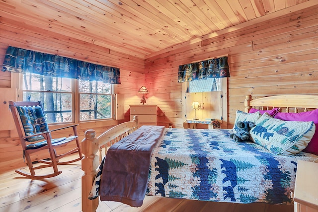 bedroom with wooden walls, light hardwood / wood-style flooring, and wood ceiling