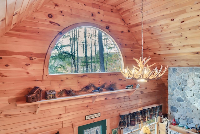 interior space featuring wooden walls, wooden ceiling, and a notable chandelier