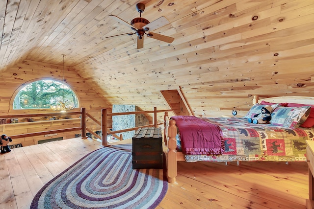 bedroom featuring ceiling fan, vaulted ceiling, wooden walls, wood ceiling, and hardwood / wood-style flooring