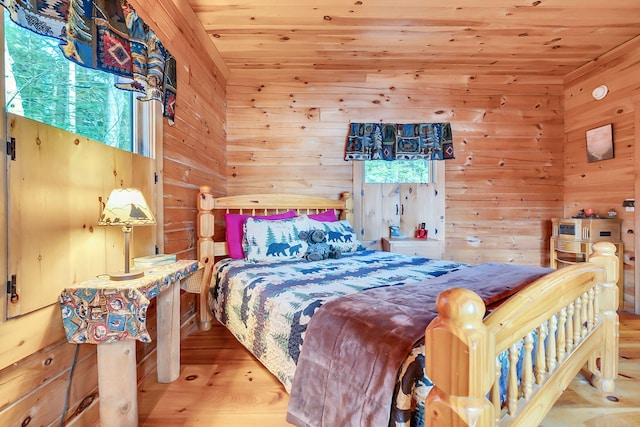 bedroom with hardwood / wood-style floors, wooden ceiling, and wood walls