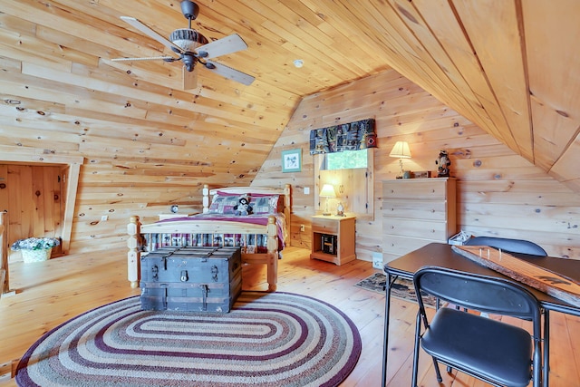 bedroom featuring wood walls, light hardwood / wood-style flooring, wooden ceiling, and lofted ceiling