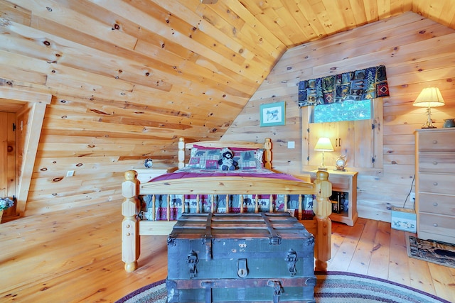 bedroom featuring wood-type flooring, vaulted ceiling, wood walls, and wood ceiling