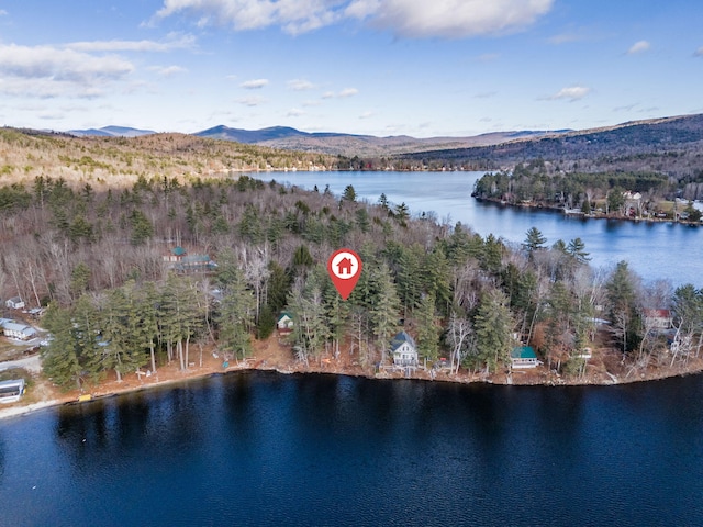 drone / aerial view featuring a water and mountain view