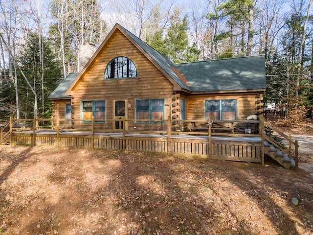 back of property with a wooden deck