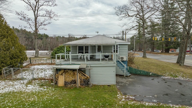 back of property with a porch and a yard