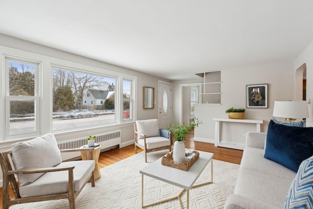 living room with radiator and light hardwood / wood-style floors