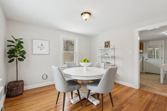 dining space featuring light hardwood / wood-style flooring and a healthy amount of sunlight