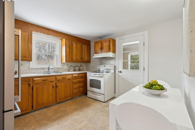 kitchen featuring electric stove, sink, and decorative backsplash