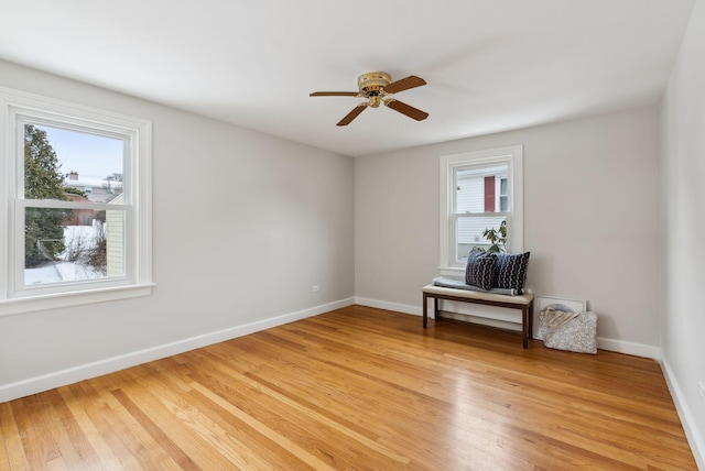 spare room with hardwood / wood-style flooring, plenty of natural light, and ceiling fan