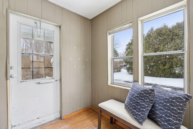 sitting room featuring wooden walls and hardwood / wood-style floors