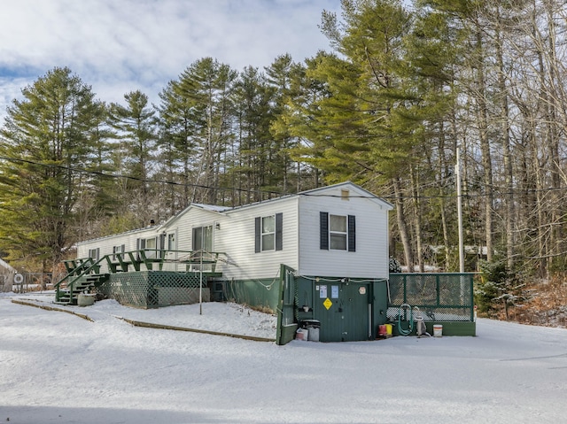 view of snowy exterior featuring a deck