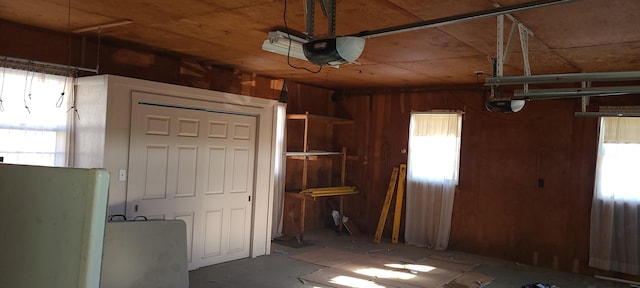 garage featuring wood walls and a garage door opener