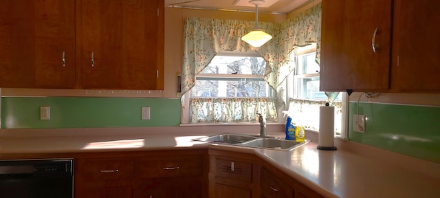 kitchen with pendant lighting, dishwasher, and sink