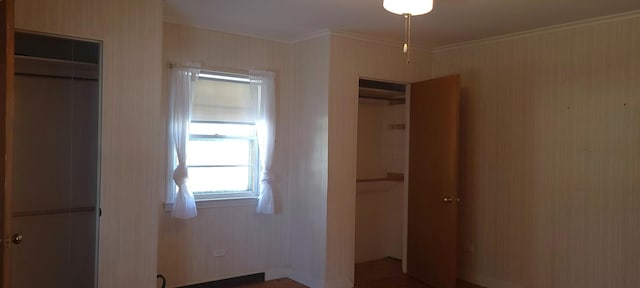 interior space with crown molding and a closet