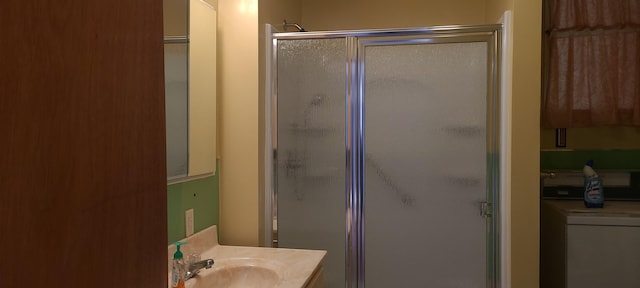 bathroom with a shower with door and vanity