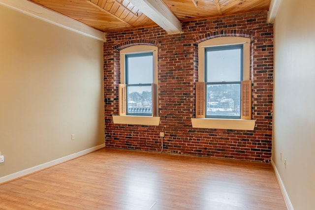 unfurnished room featuring wooden ceiling, light hardwood / wood-style flooring, a healthy amount of sunlight, and brick wall