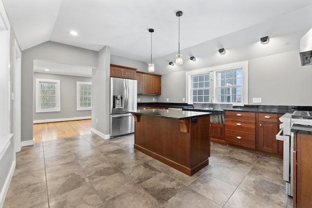 kitchen with baseboard heating, stainless steel fridge with ice dispenser, stove, lofted ceiling, and a breakfast bar