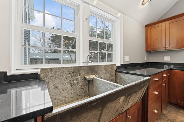 kitchen featuring tile patterned floors and lofted ceiling