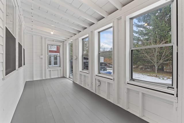 unfurnished sunroom featuring wooden ceiling and lofted ceiling with beams