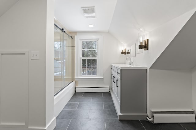 bathroom with a baseboard radiator, tile patterned flooring, lofted ceiling, shower / bath combination with glass door, and vanity