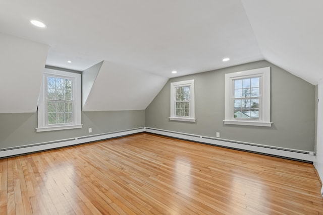 bonus room featuring light hardwood / wood-style flooring, a wealth of natural light, and lofted ceiling