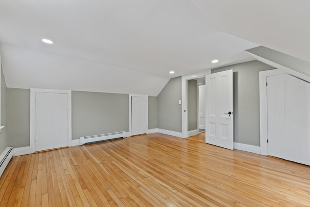 bonus room with light hardwood / wood-style floors, baseboard heating, and vaulted ceiling