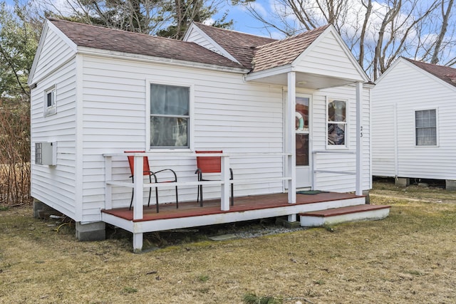 rear view of property with a lawn