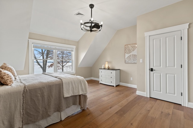 18 Sheehans Island Rd, Raymond, ME 04071 - bedroom with wood-type flooring, lofted ceiling, and a chandelier