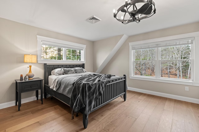 18 Sheehans Island Rd, Raymond, ME 04071 - bedroom featuring a chandelier and hardwood / wood-style floors