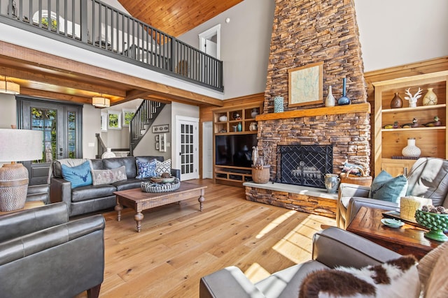 18 Sheehans Island Rd, Raymond, ME 04071 - living area featuring a high ceiling, stairs, hardwood / wood-style flooring, and a fireplace