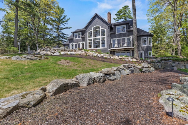 18 Sheehans Island Rd, Raymond, ME 04071 - back of property featuring a chimney and a yard