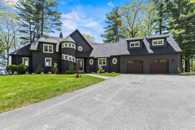 18 Sheehans Island Rd, Raymond, ME 04071 - shingle-style home with a front yard, a shingled roof, driveway, a chimney, and a garage