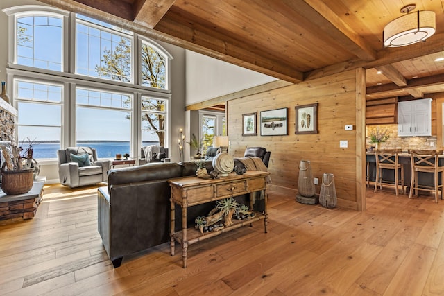 18 Sheehans Island Rd, Raymond, ME 04071 - living area featuring beam ceiling, wood ceiling, light wood-style flooring, and a water view