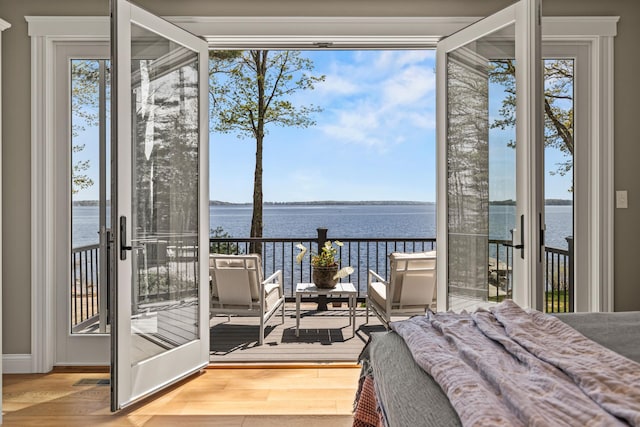 18 Sheehans Island Rd, Raymond, ME 04071 - bedroom with a water view, access to outside, and wood finished floors