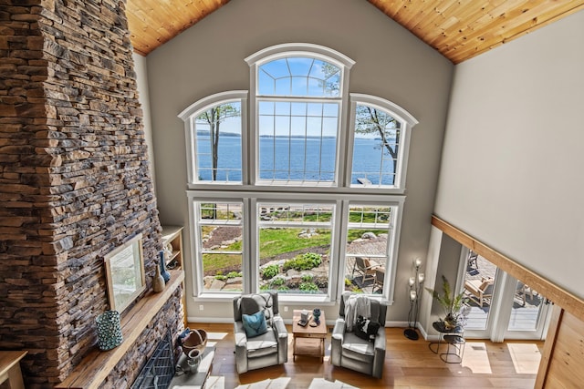 18 Sheehans Island Rd, Raymond, ME 04071 - living area featuring a water view, wood finished floors, wood ceiling, high vaulted ceiling, and baseboards