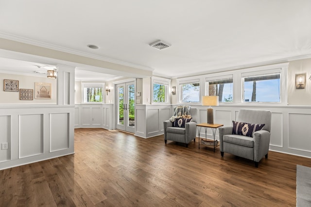 18 Sheehans Island Rd, Raymond, ME 04071 - sitting room featuring a decorative wall, ornamental molding, dark wood-style floors, decorative columns, and a wainscoted wall