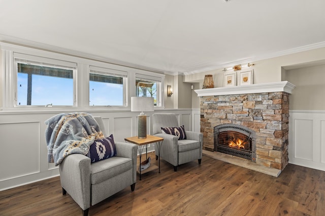 18 Sheehans Island Rd, Raymond, ME 04071 - sitting room with a decorative wall, a fireplace, crown molding, wood finished floors, and wainscoting