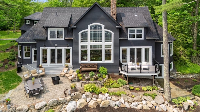 18 Sheehans Island Rd, Raymond, ME 04071 - rear view of property with a patio, a chimney, and a shingled roof