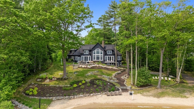 18 Sheehans Island Rd, Raymond, ME 04071 - shingle-style home with a chimney, a front yard, and view of wooded area