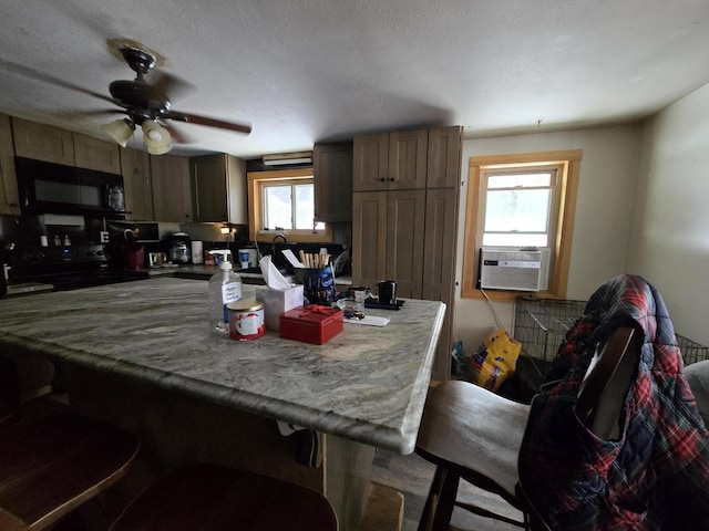 kitchen featuring black appliances, plenty of natural light, cooling unit, and ceiling fan