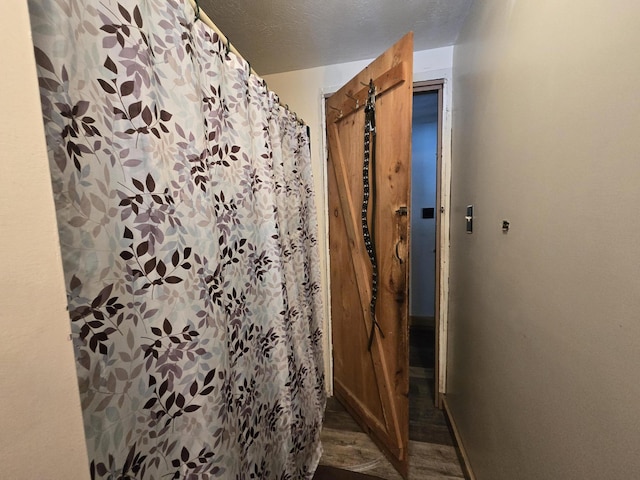 bathroom featuring hardwood / wood-style flooring and a textured ceiling