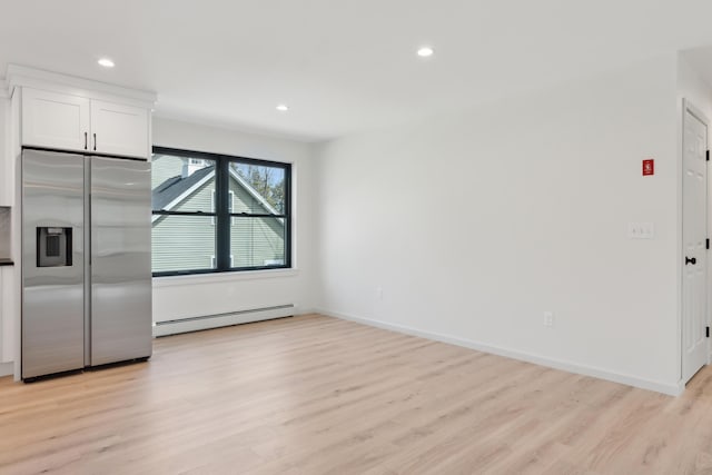 17 Ward Rd, Sebago, ME 04029 - interior space with stainless steel fridge with ice dispenser, light wood-style flooring, white cabinets, recessed lighting, and a baseboard radiator