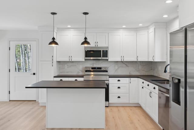 17 Ward Rd, Sebago, ME 04029 - kitchen with stainless steel appliances, light wood-style floors, a sink, and dark countertops