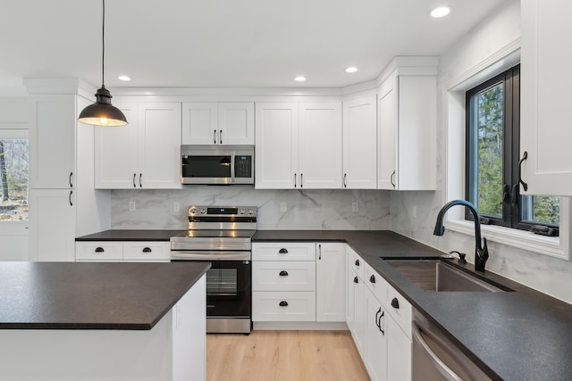 17 Ward Rd, Sebago, ME 04029 - kitchen featuring recessed lighting, dark countertops, white cabinets, stainless steel appliances, and a sink