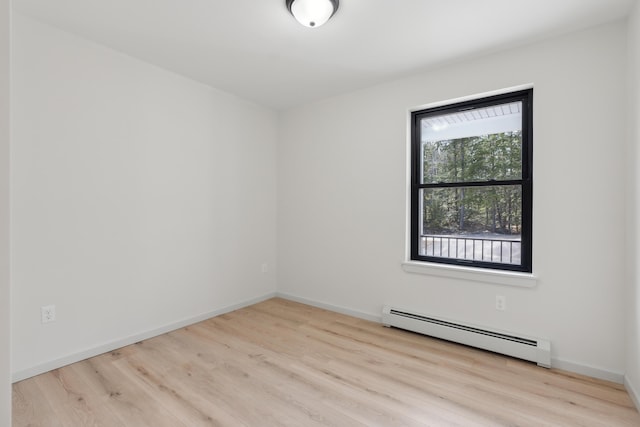 17 Ward Rd, Sebago, ME 04029 - empty room featuring a baseboard radiator, wood finished floors, and baseboards