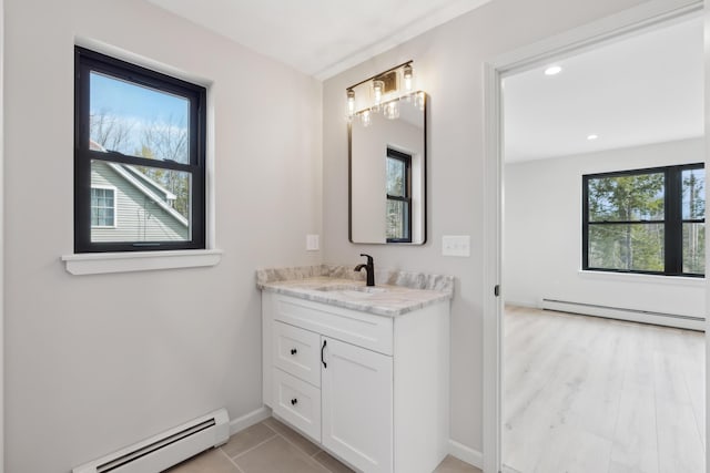 17 Ward Rd, Sebago, ME 04029 - bathroom with baseboard heating, vanity, baseboards, and recessed lighting