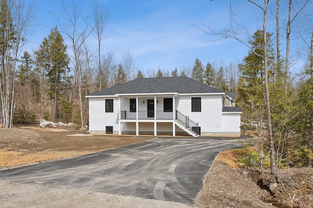17 Ward Rd, Sebago, ME 04029 - view of front of property featuring central AC, a porch, driveway, and roof with shingles