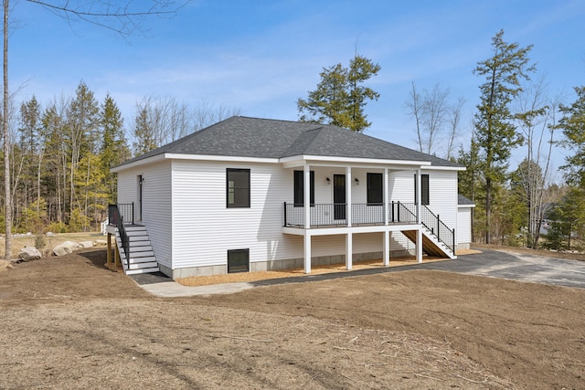 17 Ward Rd, Sebago, ME 04029 - view of front facade featuring stairway, roof with shingles, and covered porch