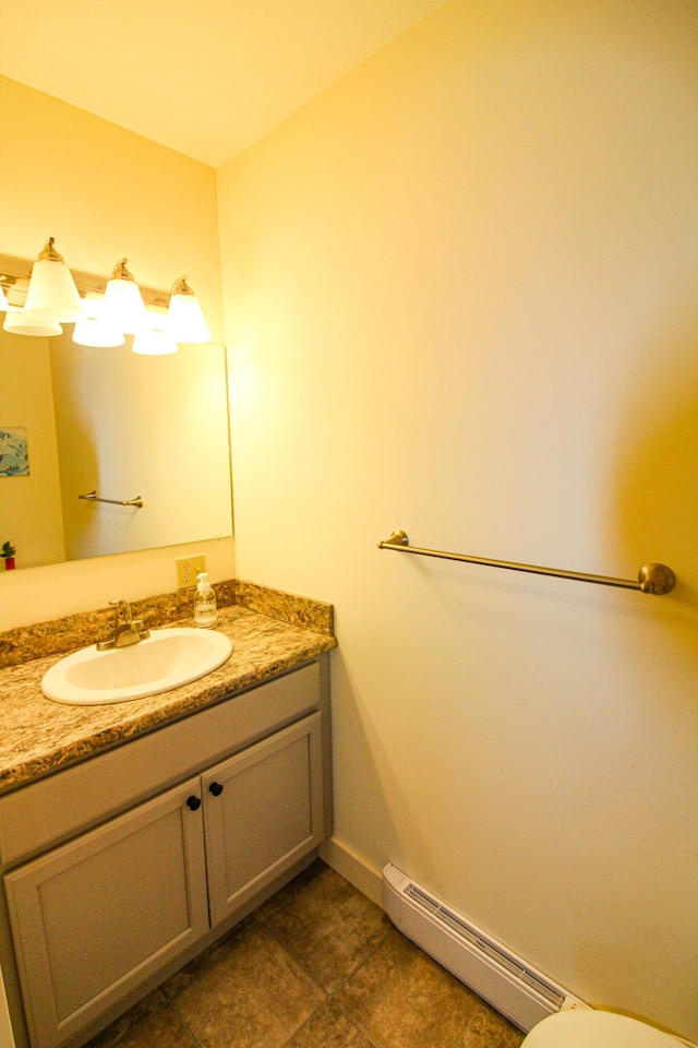 135 Vernon St Unit 4E, Bethel, ME 04217 - half bathroom with vanity, tile patterned floors, and a baseboard heating unit