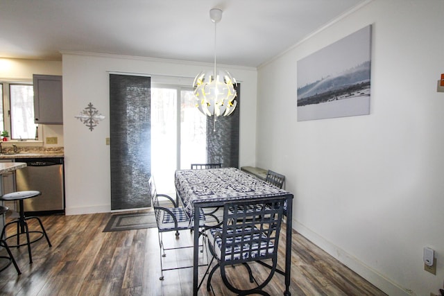 dining room with a notable chandelier, dark hardwood / wood-style floors, plenty of natural light, and ornamental molding